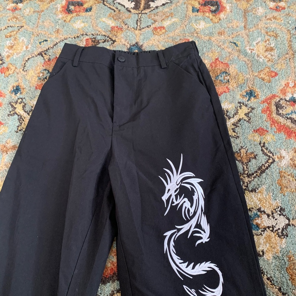 Black straight leg pants with a embroidered design